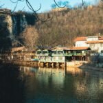 a body of water with a building on the side of it